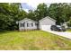Charming single-story home with gray siding, brick foundation, two-car garage, and lush green lawn at 1005 8Th Sw Ave, Conover, NC 28613