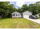 Charming single-story home with gray siding, brick accents, and a well-manicured lawn, shaded by mature trees in the front yard at 1005 8Th Sw Ave, Conover, NC 28613