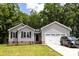 Charming single-story home with gray siding, brick accents, and a well-manicured lawn, shaded by mature trees in the front yard at 1005 8Th Sw Ave, Conover, NC 28613