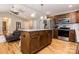 Open concept kitchen features a center island with stone countertop, stainless steel appliances, and hardwood floors at 1005 8Th Sw Ave, Conover, NC 28613
