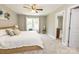 Spacious main bedroom with carpet flooring, a ceiling fan, a window with curtains, and an ensuite bathroom at 1005 8Th Sw Ave, Conover, NC 28613
