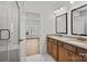 Bathroom featuring double sinks, framed mirrors, and glass enclosed shower adjacent to the main bedroom at 1006 Kinship Dr # 120, Lancaster, SC 29720