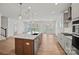 Bright, open kitchen features a large island with a stainless steel dishwasher and elegant pendant lighting at 1006 Kinship Dr # 120, Lancaster, SC 29720