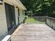 Wood deck providing outdoor seating with views of backyard and woods at 1010 Macarthur Rd, Albemarle, NC 28001