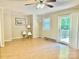Spacious living room featuring hardwood floors, ceiling fan, and a sliding glass door to outside deck at 1010 Macarthur Rd, Albemarle, NC 28001