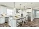 Modern kitchen with white cabinets, marble countertops, stainless steel appliances, and a large island with seating at 1022 Kinship Dr # 118, Lancaster, SC 29720