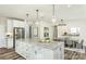 Spacious kitchen featuring a central island with modern pendant lighting and an adjacent dining area at 1022 Kinship Dr # 118, Lancaster, SC 29720