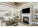 Open-concept living room with fireplace, ceiling fan, and view into the modern kitchen and dining area at 1022 Kinship Dr # 118, Lancaster, SC 29720