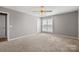 Bright bedroom with neutral walls, plush carpet, and a ceiling fan providing a calming and comfortable atmosphere at 1031 Fants Grove Ln, Indian Land, SC 29707