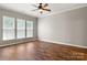 Large primary bedroom boasts multiple windows and neutral color palette at 1031 Fants Grove Ln, Indian Land, SC 29707