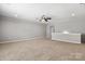 Spacious bonus room with neutral carpet, ceiling fan and a view of the hallway offering versatile living space at 1031 Fants Grove Ln, Indian Land, SC 29707