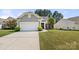 Well maintained home with a two-car garage, luscious green lawn, and mature landscaping at 1031 Fants Grove Ln, Indian Land, SC 29707
