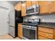 Close-up of a kitchen with stainless steel appliances, granite countertops, and light wood cabinets at 1031 Fants Grove Ln, Indian Land, SC 29707