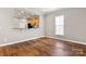 Open-concept living room featuring hardwood floors and a view into the kitchen, great for entertaining at 1031 Fants Grove Ln, Indian Land, SC 29707