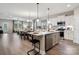 Spacious kitchen with white cabinets, stainless steel appliances, and an island with bar seating at 1045 Mapletree Ln, Indian Trail, NC 28079