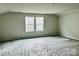 Unfurnished bonus room featuring plush carpeting and natural light through large windows at 1056 Mapletree Ln, Indian Trail, NC 28079