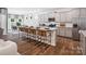 Bright kitchen features grey cabinetry, a granite island with seating, and stainless steel appliances at 1056 Mapletree Ln, Indian Trail, NC 28079