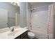 Bright bathroom with a tub and shower, vanity, and neutral finishes at 10614 Hill Point Ct, Charlotte, NC 28262