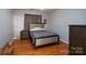 Bedroom with a bed, nightstand, and wood flooring at 10614 Hill Point Ct, Charlotte, NC 28262