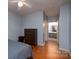 Bedroom with wood flooring and a view into the bathroom at 10614 Hill Point Ct, Charlotte, NC 28262