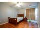 Cozy bedroom features a ceiling fan and wood-look laminate flooring at 10614 Hill Point Ct, Charlotte, NC 28262