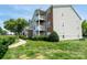 Exterior of condo with multiple balconies and lush green lawn at 10614 Hill Point Ct, Charlotte, NC 28262