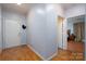 Hallway features laminate flooring and a door leading into a bedroom at 10614 Hill Point Ct, Charlotte, NC 28262