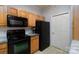 This bright kitchen features wood cabinets, black appliances, and stylish subway tile backsplash at 10614 Hill Point Ct, Charlotte, NC 28262