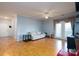 Bright and open living room featuring a ceiling fan, neutral colors, and hardwood floors at 10614 Hill Point Ct, Charlotte, NC 28262