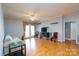 Living room featuring hardwood floors, double doors, neutral paint, and a flatscreen tv at 10614 Hill Point Ct, Charlotte, NC 28262