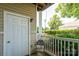 Covered porch with a chair, an exterior light, and green landscaping at 10614 Hill Point Ct, Charlotte, NC 28262