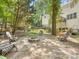 Wooded backyard features a fire pit, wood seating, play set and mature trees at 11126 Windgate Ct, Tega Cay, SC 29708