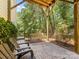 Covered patio features wood seating, wood ceiling and overlooks wooded backyard at 11126 Windgate Ct, Tega Cay, SC 29708