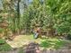 Beautiful backyard features a wooden playset with slide and swing and mature trees at 11126 Windgate Ct, Tega Cay, SC 29708