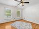 Sunlit bedroom features hardwood floors covered with a rug at 11126 Windgate Ct, Tega Cay, SC 29708