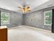 Spacious bedroom features neutral carpet, decorative ceiling fan and two windows at 11126 Windgate Ct, Tega Cay, SC 29708