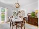 Dining room with hardwood floors, a round table with seating, and natural light streaming through the window at 11126 Windgate Ct, Tega Cay, SC 29708