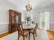 Formal dining room featuring hardwood floors, a round table with seating for four, and elegant lighting at 11126 Windgate Ct, Tega Cay, SC 29708
