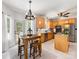 Charming eat-in kitchen features a wooden table, stainless appliances and abundant light at 11126 Windgate Ct, Tega Cay, SC 29708