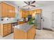 Modern kitchen with stainless steel appliances, wood cabinets, granite countertops, and a center island at 11126 Windgate Ct, Tega Cay, SC 29708
