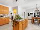 This is the kitchen with a granite countertop island, flowing into the dining and living rooms at 11126 Windgate Ct, Tega Cay, SC 29708
