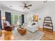Open-concept living room featuring hardwood floors and view of the kitchen and backyard at 11126 Windgate Ct, Tega Cay, SC 29708