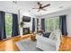 Bright living room with fireplace, hardwood floors, and large windows offering backyard views at 11126 Windgate Ct, Tega Cay, SC 29708
