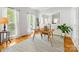 Bright office featuring hardwood floors, white walls, large windows, and a wooden desk with plants and books at 11126 Windgate Ct, Tega Cay, SC 29708