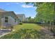 Spacious backyard featuring lush lawn and secure black metal fencing at 1209 Shelly Woods Dr, Indian Land, SC 29707