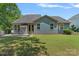 Backyard features a patio with outdoor furniture, a well-kept lawn, and mature landscaping at 1209 Shelly Woods Dr, Indian Land, SC 29707