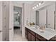 Bathroom vanity with dark wood cabinets and a view into an adjacent bedroom at 1209 Shelly Woods Dr, Indian Land, SC 29707