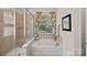 Elegant bathroom features a soaking tub, separate glass-enclosed shower, and floral patterned curtains at 1209 Shelly Woods Dr, Indian Land, SC 29707
