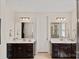 Bathroom features dual vanities, mirrors, and sinks; a clean, well-lit space at 1209 Shelly Woods Dr, Indian Land, SC 29707