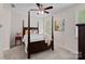 Bedroom with a four-poster bed, soft lighting, and neutral decor at 1209 Shelly Woods Dr, Indian Land, SC 29707